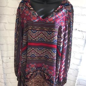 Women’s v-neck dress with long open sleeves.